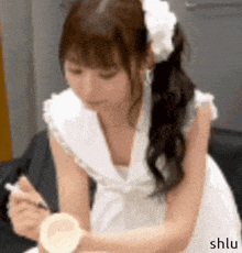 a girl with a flower in her hair is wearing a watch