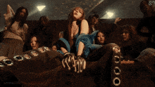 a gif of a woman sitting on a couch with the words aespagifs written on the bottom