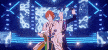 two anime characters are dancing on a stage in front of a neon background .