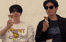 two men are holding up ice cream cones and one has a shirt that says marth francois girbaud