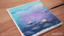 a painting of water lilies is being painted on a canvas by chloe art