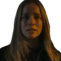 a close up of a woman 's face with a dark background