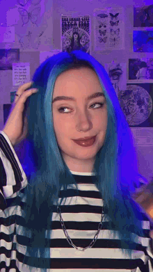 a girl with blue hair is wearing a black and white striped shirt and a necklace