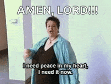 a woman is standing in a hallway and saying amen , lord !!
