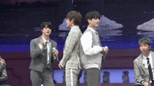 a group of men are standing next to each other on a stage .