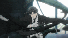 a man in a suit and tie is holding a black rope