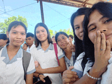 a group of young girls are posing for a picture and one of them has a bracelet on her wrist that says pearls