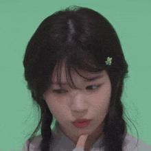 a girl with a flower in her hair looks at the camera