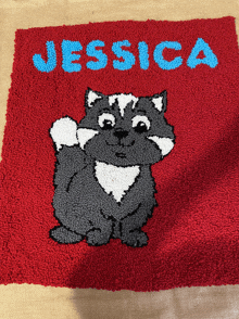 a rug with a raccoon and the name jessica written on it