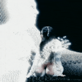 a woman in a white dress is sitting on the ground