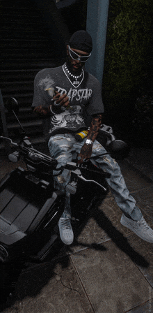 a man in a trapstar shirt sits on a scooter