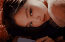 a close up of a woman 's face with the word jenz on the bottom