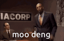 a man in a suit is standing in front of a sign that says cia corp