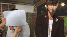a person covering another person 's face with a piece of paper while another person looks on