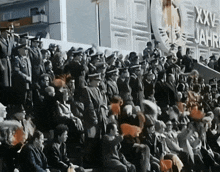a large crowd of people sitting in front of a sign that says xxx jahre