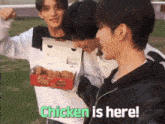 a man holding a box of chicken nuggets with the words chicken is here