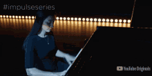 a person playing a piano on a stage with the words impulseseries written above them