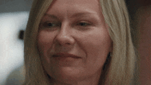 a close up of a woman 's face with blonde hair