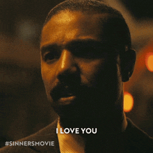 a close up of a man 's face with the words " i love you " on the bottom