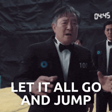 a man in a tuxedo with the number 100 on his chest says let it all go and jump