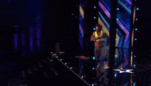 a man in a yellow vest is standing on a stage