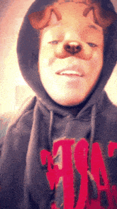 a man wearing a hoodie with the letter a on the front