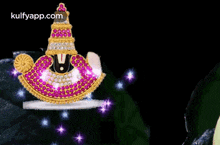 a statue of a deity with a crown on top of it is surrounded by purple and blue lights .