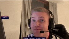 a man wearing headphones with a microphone and a replay button