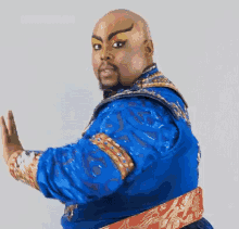 a man in a genie costume is making a hand gesture .
