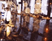 a person walking on a stage with a reflection of buildings