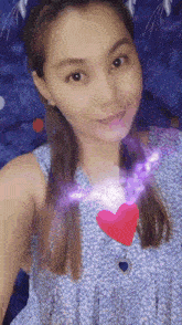 a woman is taking a selfie with a heart in her chest .