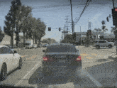 a black bmw with a california license plate that says t4j330