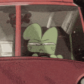 a green cartoon character is driving a red car with hearts on his face