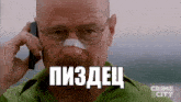 a man with glasses and a bandage on his nose is talking on a cell phone