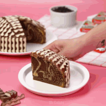 a slice of cake on a white plate with the word mr.cakes on the bottom right