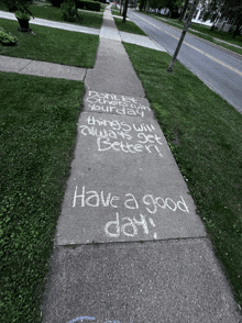 a sidewalk with the words have a good day written in white chalk