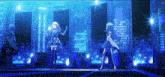 a group of anime girls are standing on a stage with a city in the background