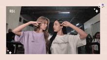 two women wearing shirts that say always wonder are posing for a picture