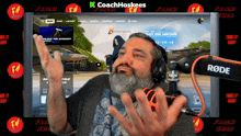 a man wearing headphones is playing a video game on a screen that says k coachhoskees