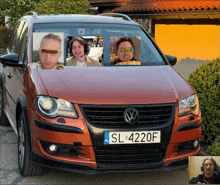 a red vw car with a license plate that says sl4220f