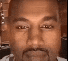 a close up of a man 's face with a beard and a mustache .