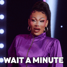 a woman in a purple jacket says wait a minute in white letters