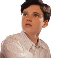 a young boy wearing a striped shirt is looking up