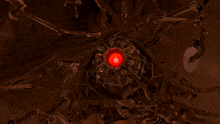 a computer generated image of a spider with a red light coming out of it