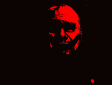 a red silhouette of a person 's face with a black background