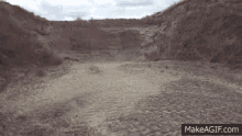 a dirt road with a makeagif.com link