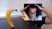 a picture of a man wearing headphones and a mask is behind a banana