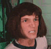 a man wearing a wig is making an angry face