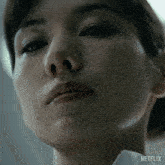 a close up of a woman 's face with the word netflix on the bottom right