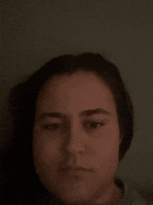 a close up of a woman 's face in the dark